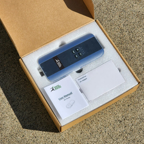 Air pump in its open packaging box with the user manual